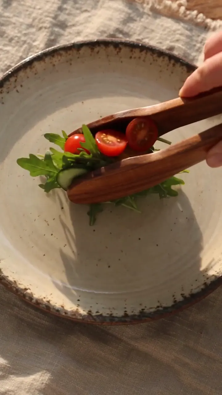 The ceramic plate styled, with a fresh salad